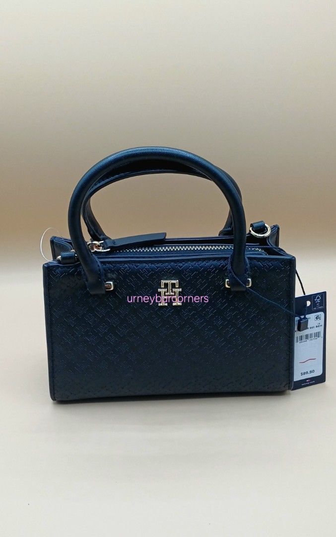 Tommy Hilfiger Black Monogram Mini Top Handle Bag (Category: Luxury Bags & Wallets) located in Imus. Submitted by urneyburcorners (Listing ID 1455678210, Image 3). Description: - Authentic Tommy Hilfiger mini top handle bag - Features iconic TH monogram embossed pattern - Elegant gold hardware details - Includes both top handles and a detachable shoulder strap - Comes with original tags attached - Versatile for both everyday use and evening outin