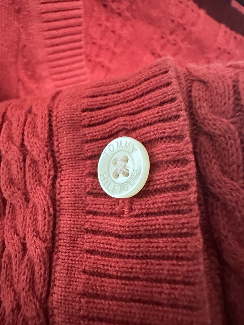 Tommy Hilfiger Red Cable Knit Button Up Cardigan (Category: Coats, Jackets and Outerwear) located in Calamba. Submitted by berngundy (Listing ID 1455767246, Image 2). Description: - Classic red Tommy Hilfiger cable knit cardigan - V-neckline - Button-up front with embossed Tommy Hilfiger logo buttons - Versatile for layering over tops or dresses - Comfortable and stylish.