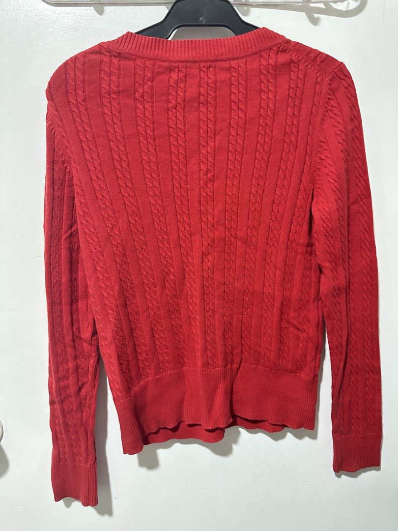 Tommy Hilfiger Red Cable Knit Button Up Cardigan (Category: Coats, Jackets and Outerwear) located in Calamba. Submitted by berngundy (Listing ID 1455767246, Image 3). Description: - Classic red Tommy Hilfiger cable knit cardigan - V-neckline - Button-up front with embossed Tommy Hilfiger logo buttons - Versatile for layering over tops or dresses - Comfortable and stylish.
