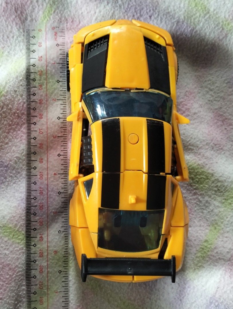 Transformers Bumblebee Camaro Toy Car (Category: Vehicle & Diecast Models) located in Pasig City. Submitted by kat_grande (Listing ID 1455702333, Image 3). Description: - Yellow and black Bumblebee Camaro toy car - Doors open - Detailed interior and exterior - Measures approximately 15cm long - Ideal for collectors and play - A must-have for any Transformers fan.
