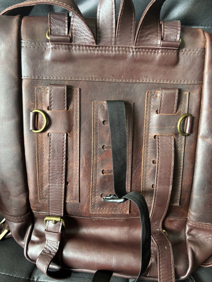 T.S.M. Motorcycle Leather Roll Top Backpack (Category: Backpacks) located in Caloocan City. Submitted by gvv013 (Listing ID 1455720143, Image 3). Description: - Dark brown leather roll-top backpack - Brand: T.S.M. The Bag Maker - Features adjustable straps and buckle closures - Leather shows some scuffing and marks (please check photos for details) - Plenty of interior space for essentials -Issue: see pic. Slight discoloration due to removal of p