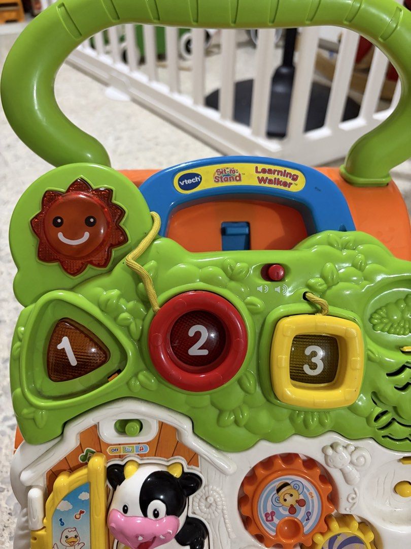 VTech First Step Baby Walker (Category: Infant Playtime) located in Manila. Submitted by carlypots (Listing ID 1455751518, Image 2). Description: - VTech Sit-to-Stand Learning Walker - Interactive activities: piano keys, gears, cow character - Aids in developing motor skills and learning - Perfect for babies learning to walk - Sturdy handle for support - Bright and engaging colors - Missing phone (as shown in photos), will include if ever I find 