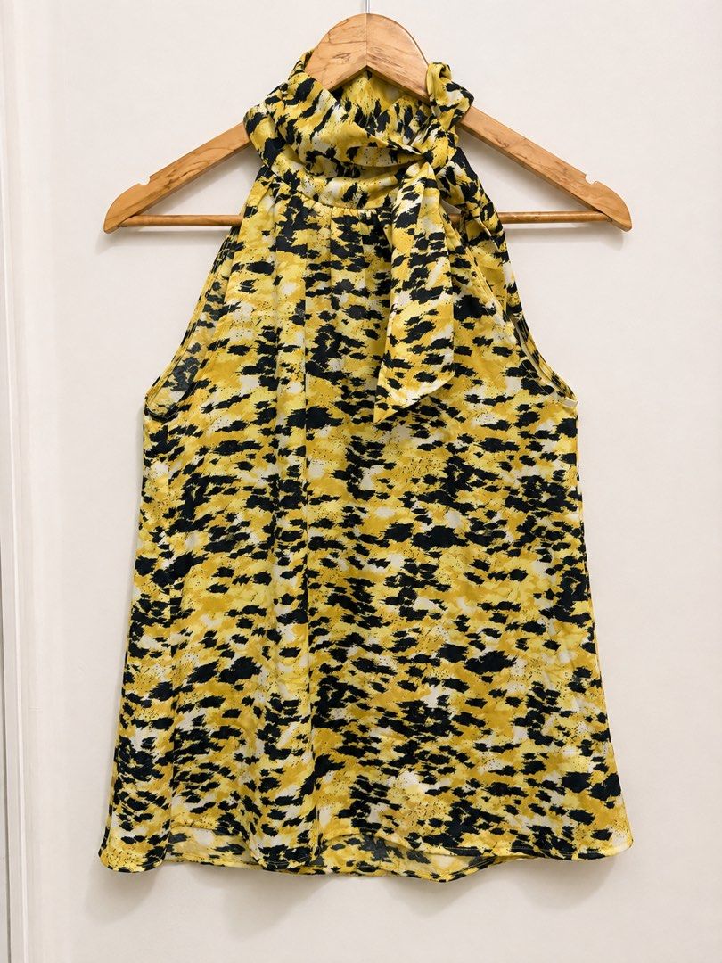 Yellow Black Abstract Print Halter Neck Top with Bow (Category: Sleeveless) located in Subic. Submitted by ysbllrs (Listing ID 1455851252, Image 1). Description: - Cute halter neck top - Fun abstract print in yellow, black, and white - Ties at the neck with a bow - Sleeveless design - Perfect for dressing up or down - Pairs well with jeans or skirts.