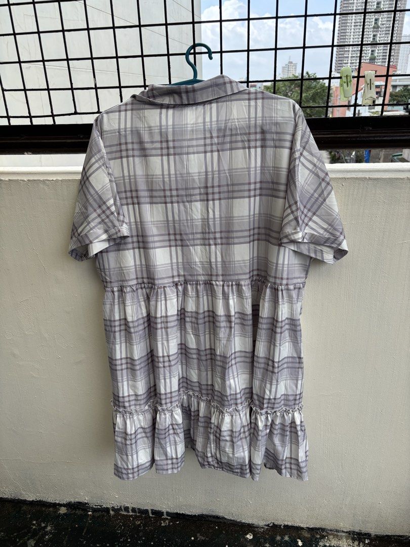 2XL Plaid Button-Up Tiered Ruffle Dress (Category: Dresses) located in Manila. Submitted by decluttergivebing (Listing ID 1455907850, Image 3). Description: - Casual plaid design - Button-up front - Short sleeves - Tiered hem with ruffles - Made from polyester and elastane blend - Ideal for everyday wear.