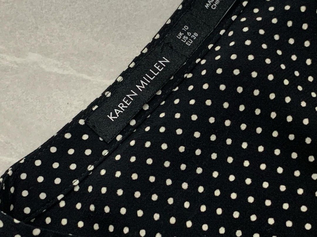 🌷 Karen Millen🌷 (Category: Luxury Apparel) located in Iba. Submitted by selector_items (Listing ID 1456031433, Image 3). Description: ​Brand: Karen Millen ​Condition: As new ​Size: UK 10 / US 6 / EU 38 (equivalent to XS–Medium range depending on fit) ​Design/Details: ​Black long-sleeve blouse with an all-over white/cream polka dot print. ​Statement ruffle trim detailing along the shoulders and front placket. ​Button-up front closure and high ne