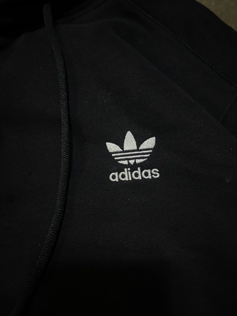 Adidas Black Sweatshirt with White Stripes (Category: Coats, Jackets and Outerwear) located in Malabon City. Submitted by yivsthrift (Listing ID 1455996337, Image 2). Description: - Classic black Adidas sweatshirt - Features iconic white three stripes on sleeves - Embroidered Adidas trefoil logo on chest - Approximate measurements: 27" length x 20.5" width - Ideal for everyday casual wear.