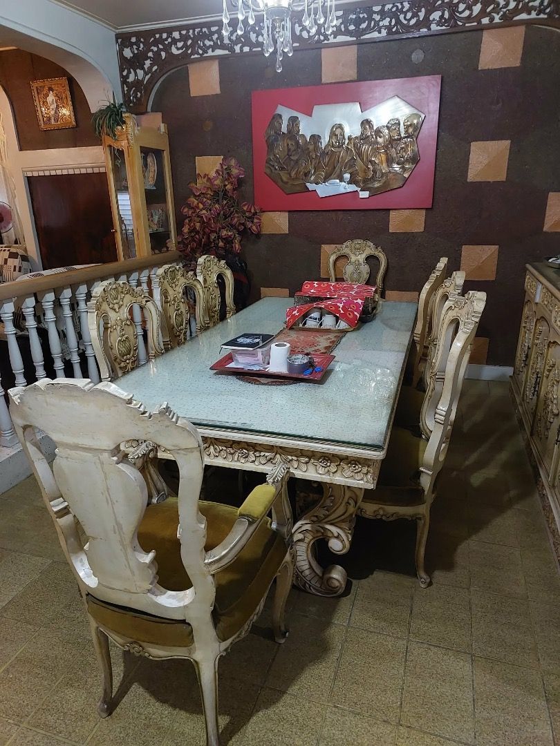 Antique Dining Table and Chairs Set (Category: Tables & Sets) located in Caloocan City. Submitted by panda.paola (Listing ID 1455881382, Image 1). Description: - Beautiful antique narra dining set - Large table with glass top and ornate carvings - Includes 6 matching chairs upholstered in plush velvet - Classic, timeless design - Perfect for formal dining rooms - Ideal for family gatherings and entertaining guests.