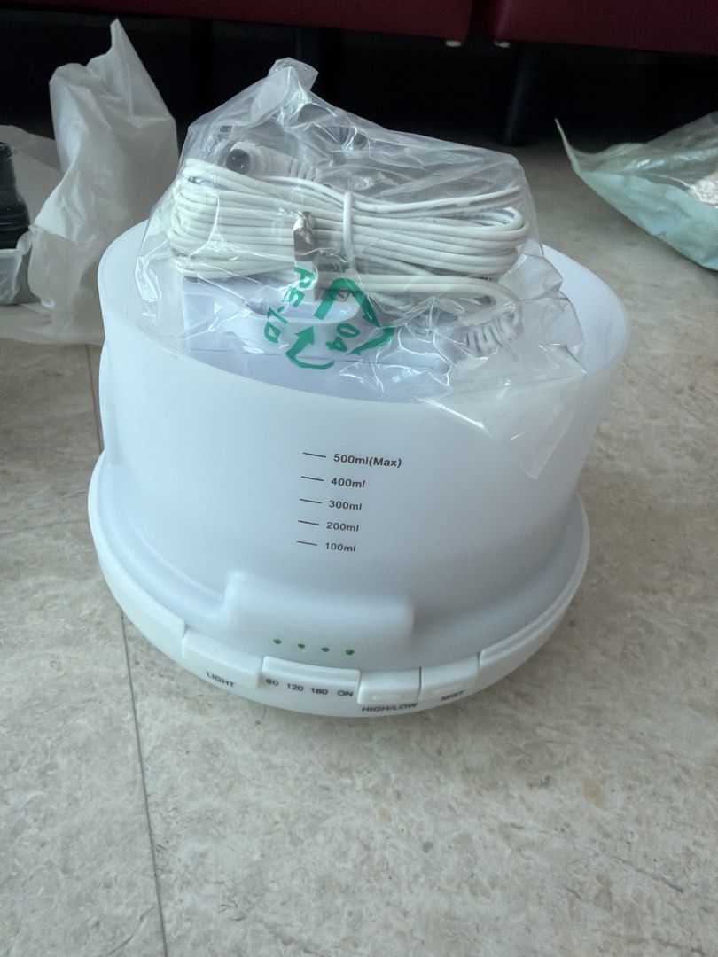 Aroma Diffuser (Category: Air Purifiers & Dehumidifiers) located in Singapore. Submitted by lynn0497 (Listing ID 1455882607, Image 2). Description: - White aroma diffuser - Includes original box and power adapter - Creates a relaxing atmosphere - Clean, modern design.