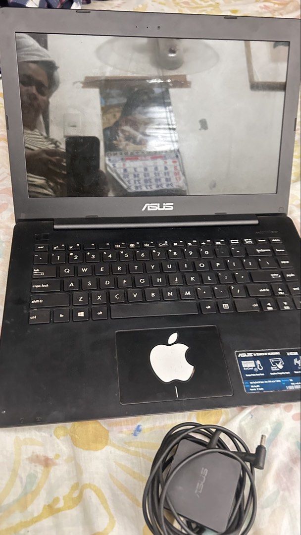 ASUS X453M Laptop with Charger (Category: Laptops & Notebooks) located in Makati City. Submitted by jaja_000011 (Listing ID 1455892597, Image 1). Description: - ASUS X453M Laptop - Includes original ASUS charger - QWERTY keyboard layout - Features an Apple logo sticker on the palm rest - Ideal for everyday tasks and web browsing - Ready for a new owner.
