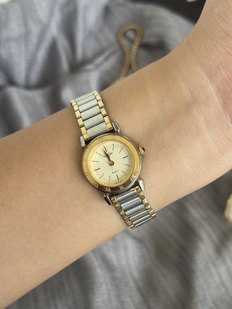 Aureole Quartz Two-Tone Watch (Category: Women's Watches) located in Puerto Princesa. Submitted by dailywristual (Listing ID 1455895183, Image 1). Description: Aureole Quartz Two-tone Watch - Two-tone metal band (Silver & Gold) - Cream dial with classic Roman numerals - Slight fadings on gold tone - 25 centavos sized dial, adjustable band for any wrist size - all original, see photos for more info - good working condition - comes with standard bo