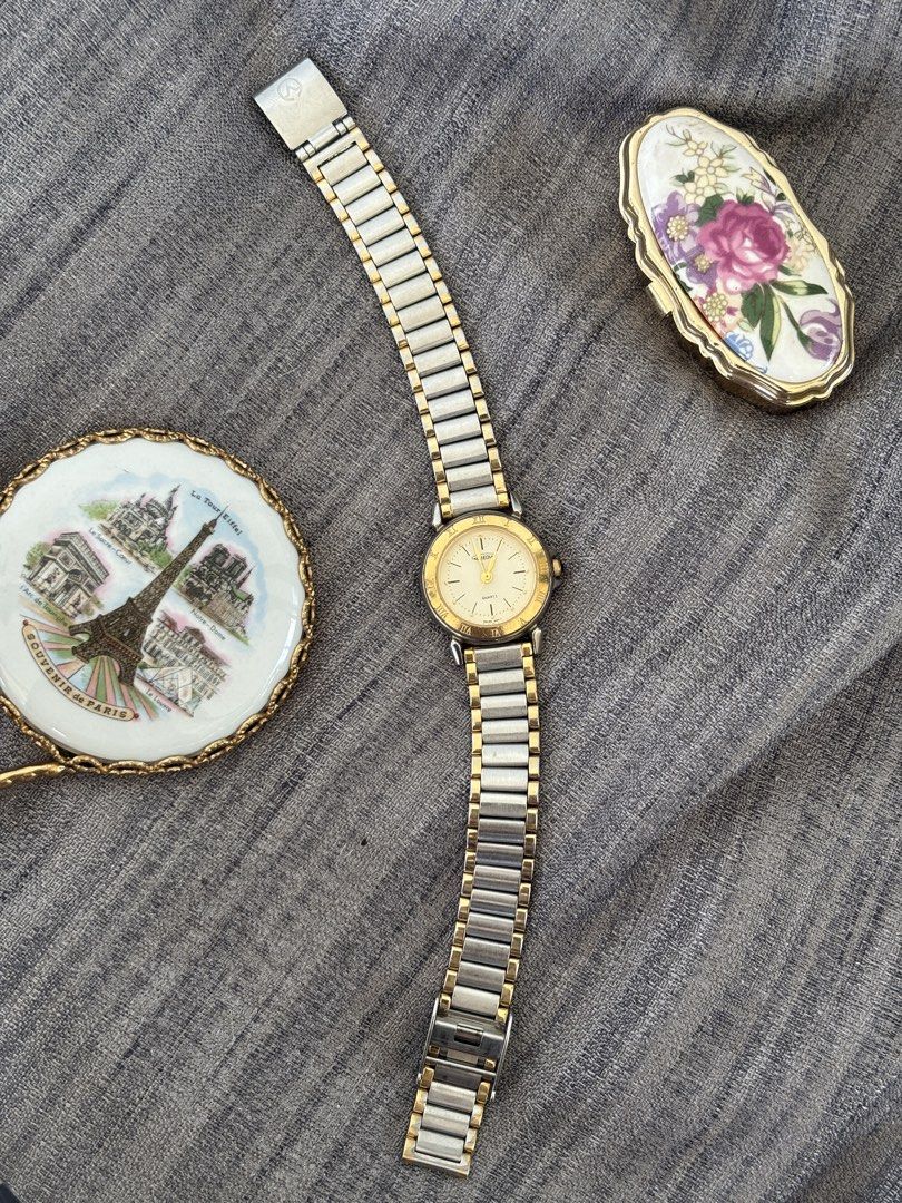 Aureole Quartz Two-Tone Watch (Category: Women's Watches) located in Puerto Princesa. Submitted by dailywristual (Listing ID 1455895183, Image 2). Description: Aureole Quartz Two-tone Watch - Two-tone metal band (Silver & Gold) - Cream dial with classic Roman numerals - Slight fadings on gold tone - 25 centavos sized dial, adjustable band for any wrist size - all original, see photos for more info - good working condition - comes with standard bo
