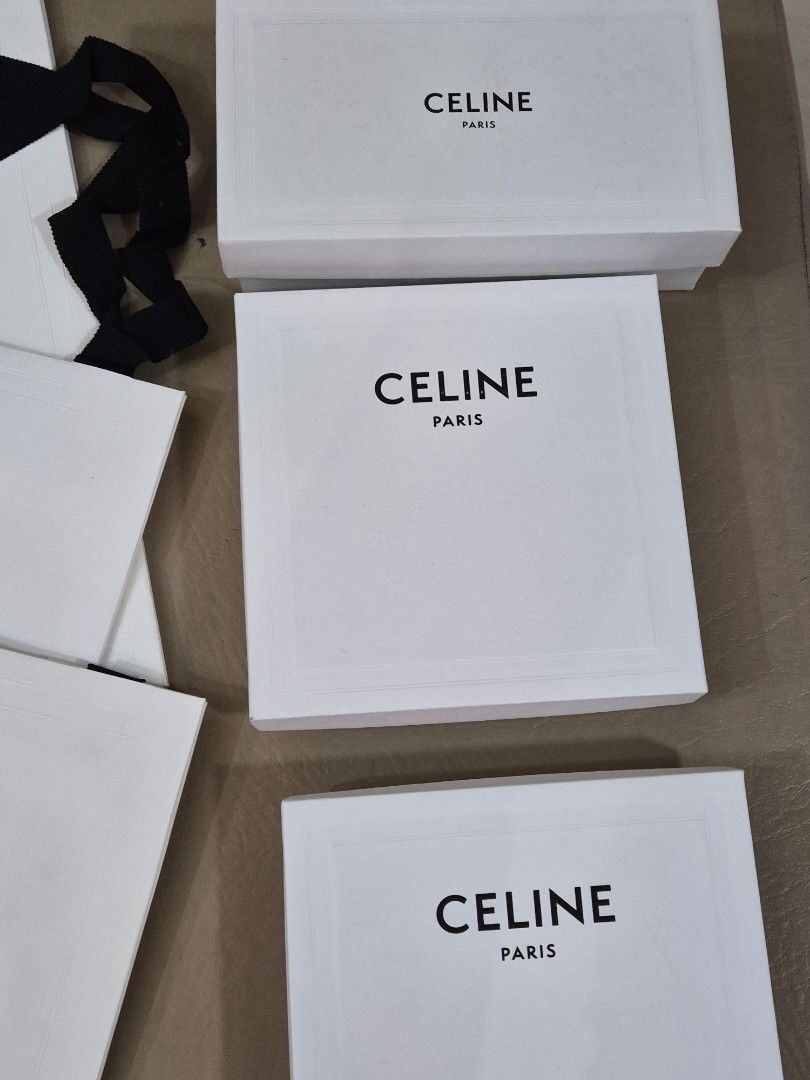 Authentic Celine Paris Shopping Bags and Gift Boxes (Category: Luxury Bags & Wallets) located in Manila. Submitted by inlababoqueen (Listing ID 1455972784, Image 2). Description: - Authentic Celine Paris shopping bags and gift boxes. - Includes white paper bag with black ribbon handles. - Features white gift boxes, some with elegant black interiors. - Ideal for storing or gifting luxury fashion items. - Perfect for Celine collectors or enthusiast
