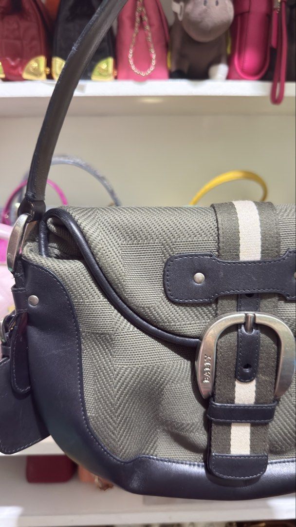 Bally Shoulder Bag Green Canvas Leather Trim (Category: Luxury Bags & Wallets) located in Taguig. Submitted by sonsing (Listing ID 1455949484, Image 3). Description: - Authentic green Bally shoulder bag - Iconic Bally stripe detail - Genuine leather trim and strap - Secure silver buckle closure - Ample interior space for essentials - Ideal for everyday wear - Comes with original leather tag.