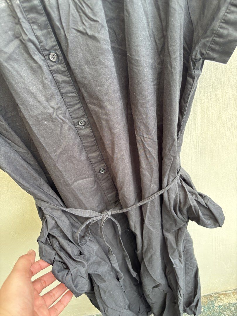 Black Button-Up Midi Dress with Belt (Category: Dresses) located in Manila. Submitted by decluttergivebing (Listing ID 1455907904, Image 3). Description: - Classic black midi dress - Short sleeves - Collared neckline - Button-up front - Includes a tie belt for waist definition - Fabric has a subtle textured pattern - Versatile for casual or dressed-up looks.