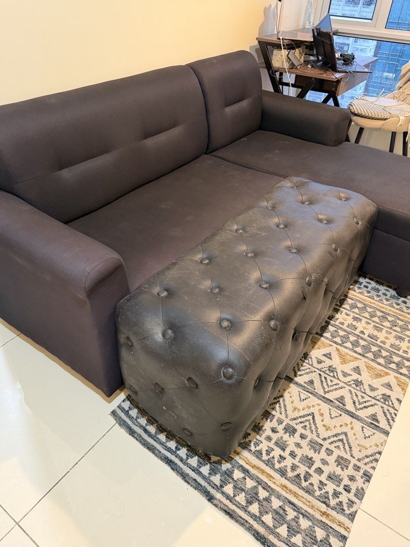 Black L-Shaped Sofa with Ottoman (Category: Sofas) located in Manila. Submitted by pathealy (Listing ID 1455900270, Image 3). Description: - Black L-shaped sofa - Includes a tufted ottoman (can be used as a footrest or extra seating) - Ottoman has some wear and tear on the edges - Comfortable and spacious design - Ideal for living rooms - Pickup only.