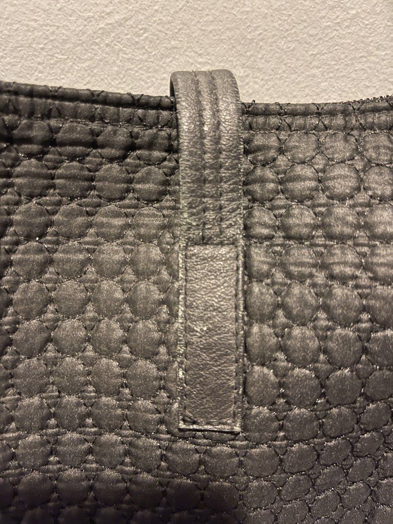 Black Textured Tote Bag with Adjustable Strap (Category: Tote Bags) located in Muntinlupa City. Submitted by cheeeeky (Listing ID 1455973853, Image 2). Description: - Stylish black tote bag with a unique textured pattern. - Main compartment for ample storage. - Detachable and adjustable shoulder strap for versatile carrying. - Features an embossed ‘CRL' leather tag on the front. - Ideal for everyday use..