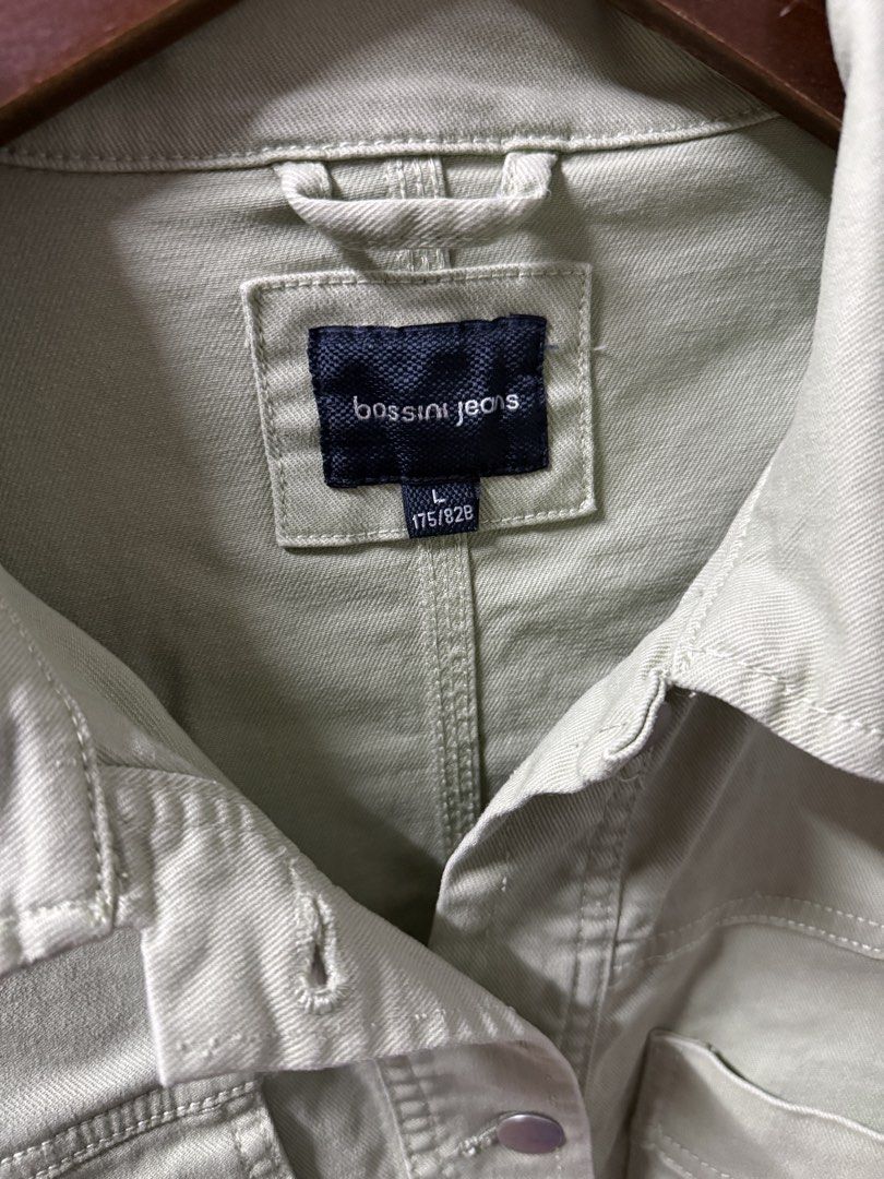Bossini Jeans Sage Green Type 2 Denim Jacket (Category: Coats, Jackets and Outerwear) located in Cavite. Submitted by g1mon (Listing ID 1455989800, Image 3). Description: This item is preloved (not thrifted) (barely used) Tagged size: Large Measurements (inches): Pit-to-pit: 20.5 Length: 21 Issues: None *Note: Lighting may affect the colour in the image* - Sage green denim jacket from Bossini Jeans - Size L - Two chest pockets - Frayed hem detail