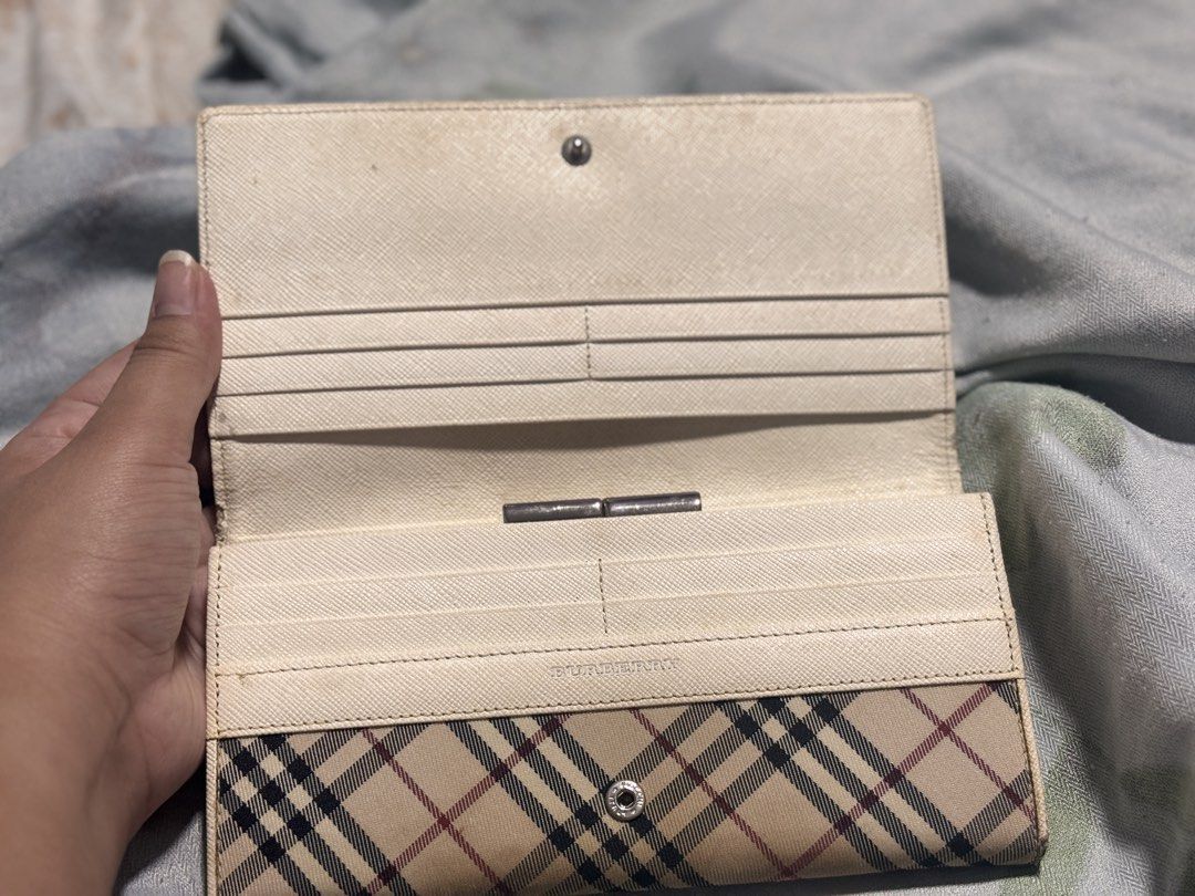 Burberry Nova Check Leather Long Wallet (Category: Luxury Bags & Wallets) located in Cavite. Submitted by _rand0mstuff4u (Listing ID 1455939177, Image 2). Description: - Classic Burberry Nova Check Leather wallet - Beige and red plaid pattern with cream leather trim - Multiple card slots and compartments - Secure snap closure - RFS: need funds Negotiable just pm me.