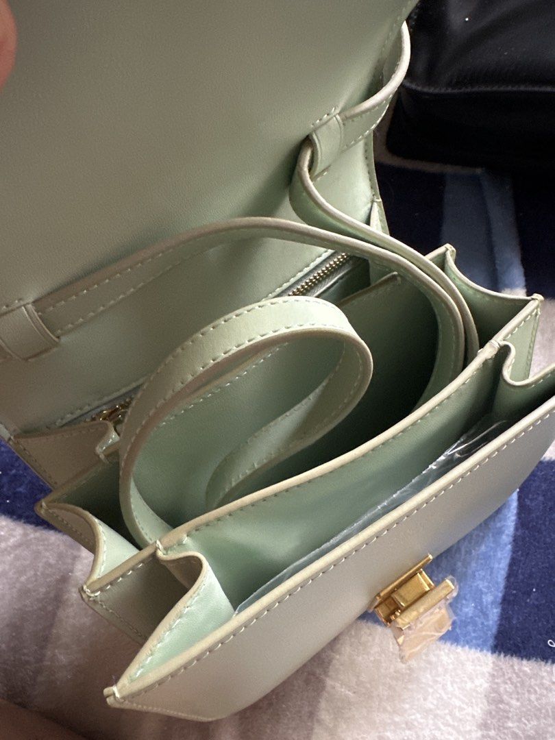 Celine Paris Light Green Leather Shoulder Bag (Category: Luxury Bags & Wallets) located in Pasig City. Submitted by the_bag_agent (Listing ID 1455857040, Image 3). Description: - Light green NGA Celine Paris shoulder bag - Genuine leather material - Elegant gold hardware clasp - Multiple interior compartments for organization - Adjustable strap for comfortable wear - clean inside and out - Versatile for daily use or special events.
