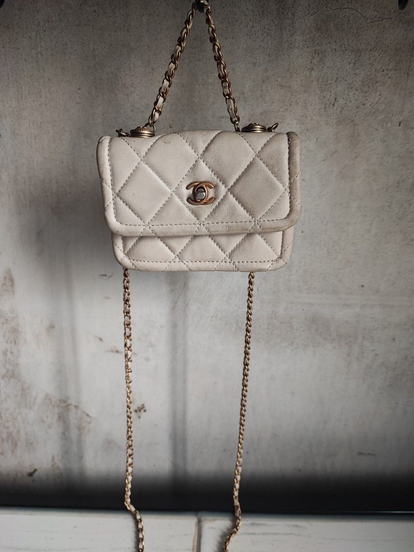 Chanel Quilted Chain Bag White (Category: Luxury Accessories) located in Tarlac. Submitted by venuslim1624398 (Listing ID 1455887727, Image 1). Description: - Preloved from Japan - White quilted mini bag - Classic Chanel-inspired style - Compact size, ideal for essentials - Features gold hardware.