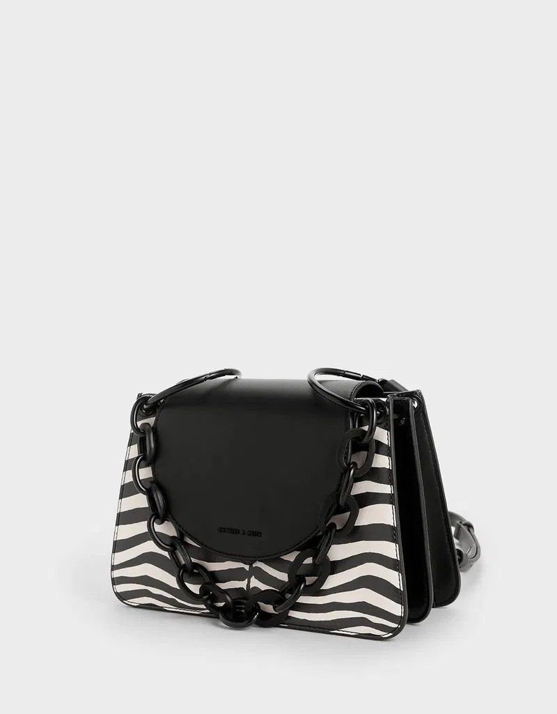 Charles & Keith Chunky Chain Zebra Print Shoulder Bag (Category: Shoulder Bags) located in Cordova. Submitted by aux.archive (Listing ID 1456003112, Image 2). Description: Charles & Keith Chunky Chain Zebra Print Shoulder Bag 7x10 issue can be seen sa last pics Good condition .
