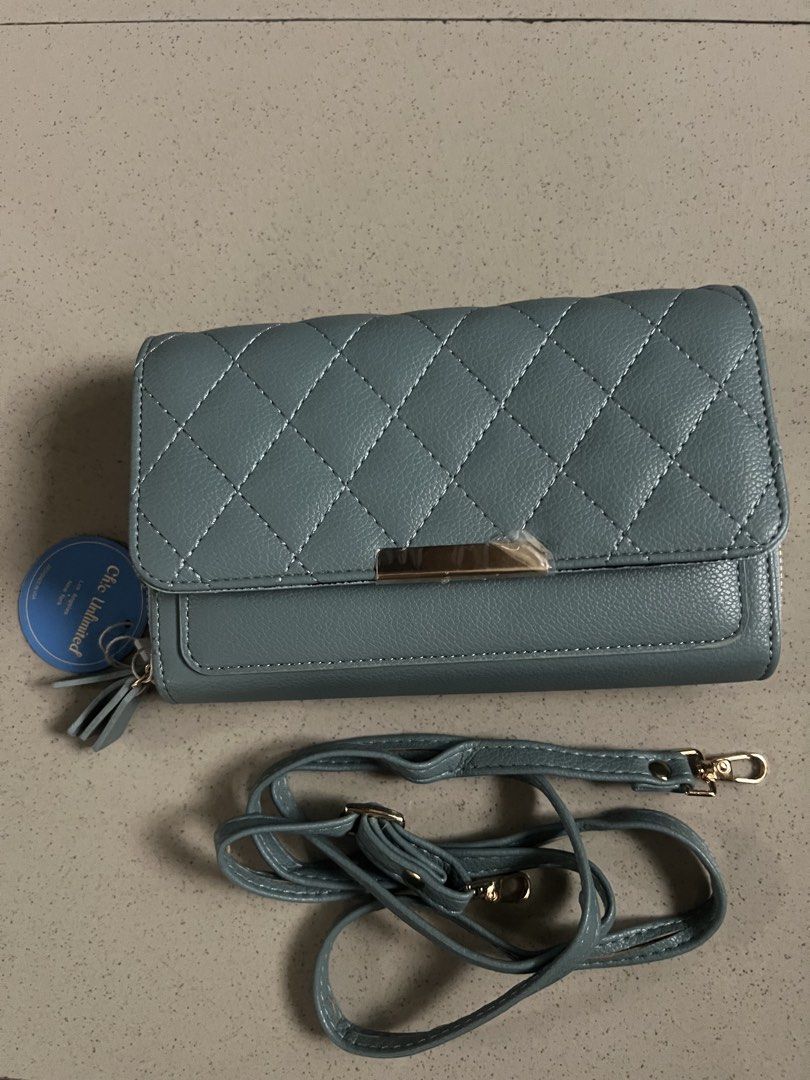 Chic Unlimited Quilted Wallet Purse with Strap (Category: Wallets & Card holders) located in Angeles City. Submitted by safe.simpledesign (Listing ID 1455932394, Image 1). Description: - Chic light blue quilted wallet purse - Features a secure zip compartment - Multiple card slots for organization - Includes a convenient detachable strap - Elegant gold hardware details - Brand new with tag still attached - Generous size: approximately 8 inches wi