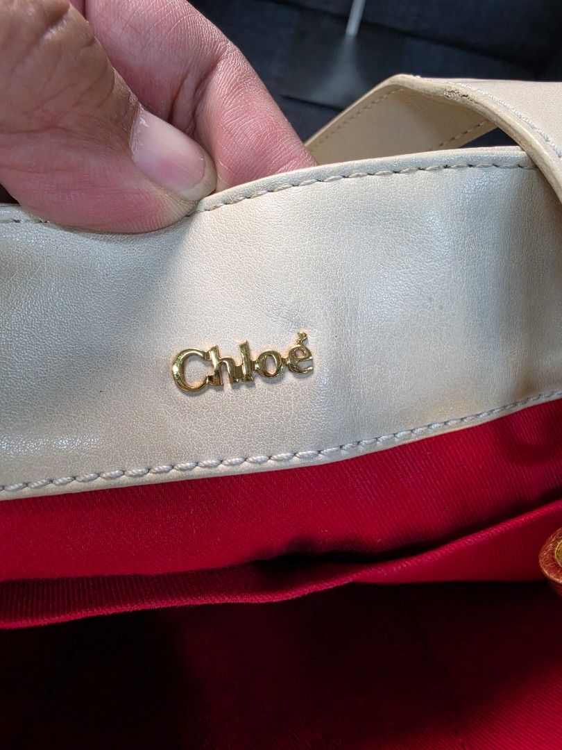Chloe Leather Handbag (Category: Luxury Bags & Wallets) located in General Trias. Submitted by roselle2230 (Listing ID 1455999502, Image 3). Description: - Genuine white leather Chloe handbag - Elegant gold hardware details - Luxurious red fabric interior lining - Proudly made in Bulgaria - Serial number clearly visible inside - A quintessential Chloe classic piece.