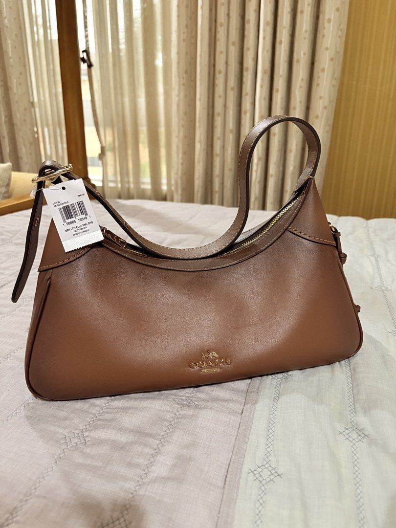 Coach Brown Leather Ella Small Hobo Bag (Category: Luxury Bags & Wallets) located in Manila. Submitted by sofiacarm15 (Listing ID 1456052334, Image 1). Description: - Authentic Coach Ella Small Hobo bag - Color: Brown - Material: Leather - Closure: Zip - Includes: Detachable strap - Interior: Coach tag - Condition: Brand new with original tags attached.