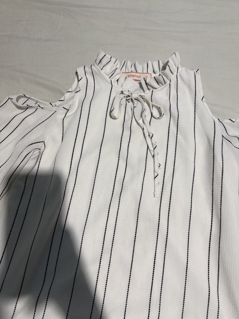 Cold Shoulder Ruffle Neck Top Size S (Category: Blouses) located in Santa Rosa. Submitted by micstuff (Listing ID 1456010492, Image 1). Description: - White top with black vertical stripes - Cold shoulder design - Long sleeves - Ruffle detail around the neckline - Tie-up front - Brand: GTWFAB - Size: S - Versatile for casual outings or dressing up.