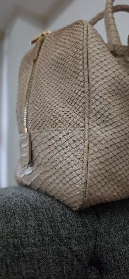 Couronne Python Embossed Leather Handbag with Sling (Category: Luxury Bags & Wallets) located in Manila. Submitted by amc88 (Listing ID 1456022644, Image 3). Description: - Beige Couronne handbag - Python-embossed leather - Gold-tone zipper and hardware - Includes matching leather tag - Spacious interior for essentials - Versatile for daily use or special occasions.