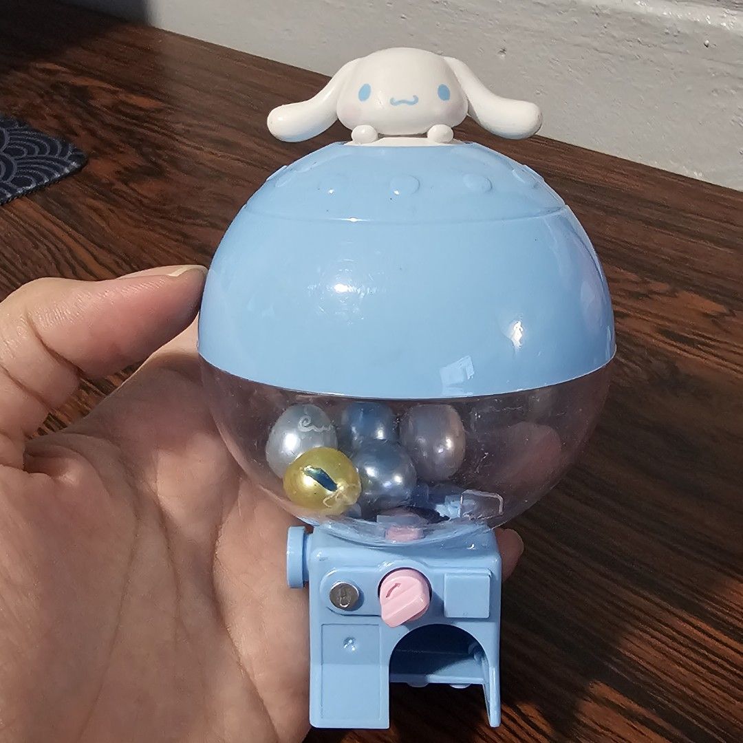 Cute Cinnamoroll gacha Machine Toy with Charms (Category: Character Goods) located in Rizal. Submitted by viviperera (Listing ID 1456025965, Image 1). Description: - Adorable Cinnamoroll gacha machine - Includes several cute charms inside - Features a yellow bell charm - Blue dispenser with a pink button - Perfect for collecting or as a fun desk accessory - Great for Sanrio character fans.