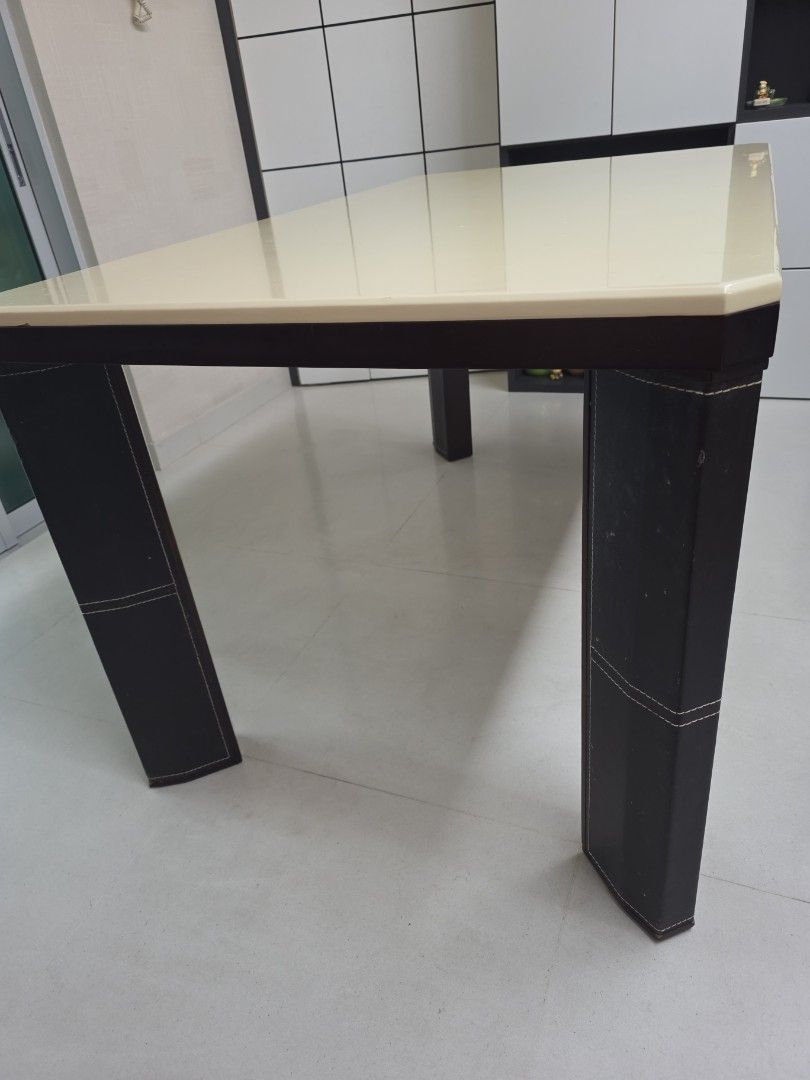 Dining Table (Category: Tables & Sets) located in Singapore. Submitted by sundrythisandthat (Listing ID 1455909540, Image 1). Description: - Modern dining table with a smooth, light-colored (off white) tabletop. - Sturdy dark legs with stylish black wrapping and white stitching. - Good to sit 6 people - Meadurements: table top 140cm X 85cm, height 76cm -Minor flaw on table top. Not for fussy buyer. - Buyer to arrange pick up from my place near ci
