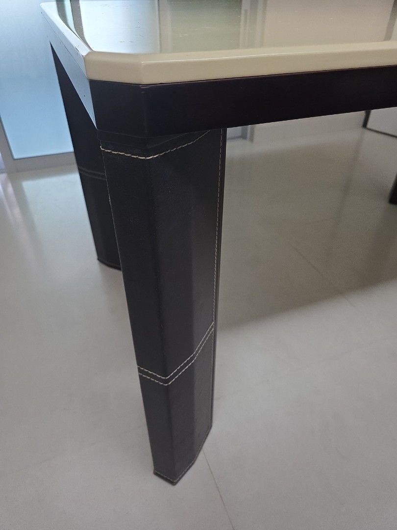 Dining Table (Category: Tables & Sets) located in Singapore. Submitted by sundrythisandthat (Listing ID 1455909540, Image 3). Description: - Modern dining table with a smooth, light-colored (off white) tabletop. - Sturdy dark legs with stylish black wrapping and white stitching. - Good to sit 6 people - Meadurements: table top 140cm X 85cm, height 76cm -Minor flaw on table top. Not for fussy buyer. - Buyer to arrange pick up from my place near ci