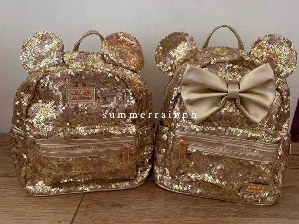 DISNEY MICKEY / MINNIE BAG (Category: Diaper Bags & Wetbags) located in Valenzuela. Submitted by summerrainph (Listing ID 1455897349, Image 1). Description: * Sequin with minnie / mickey logo * Mickey / Minnie ears design * Top handle + soft adjustable back straps * Double easy pull up zip opening * Mini but spacious * Front zip pocket * 27*23*10 cm.