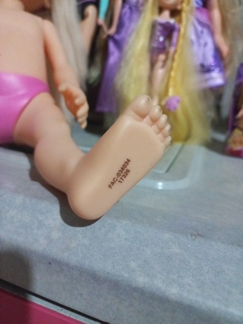 Disney Princess Doll Aurora (Category: Kids Toys) located in Cavite. Submitted by ellave (Listing ID 1456002515, Image 3). Description: - Blonde hair doll with striking purple eyes. - Comes with a cute pink bikini bottom. - Features unique markings on the foot and neck. - Perfect for doll collectors or for playtime fun! Cut Hair.
