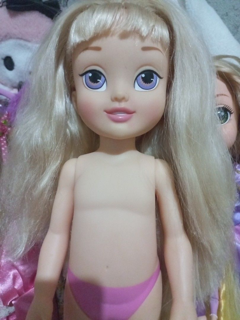 Disney Princess Doll Aurora (Category: Kids Toys) located in Cavite. Submitted by ellave (Listing ID 1456002515, Image 2). Description: - Blonde hair doll with striking purple eyes. - Comes with a cute pink bikini bottom. - Features unique markings on the foot and neck. - Perfect for doll collectors or for playtime fun! Cut Hair.