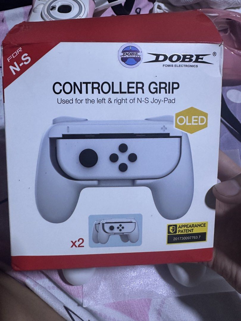 DOBE Controller Grip for N-S Joy-Pad OLED (Category: Controllers) located in Manila. Submitted by edgiedge (Listing ID 1456022372, Image 2). Description: - Enhance your N-S OLED Joy-Pad gaming experience. - Includes a pair (x2) of grips for both left and right Joy-Cons. - Designed specifically for the Nintendo Switch OLED model. - Features a unique appearance patent. - Enjoy a more comfortable and secure grip during gameplay. 📍Tondo.