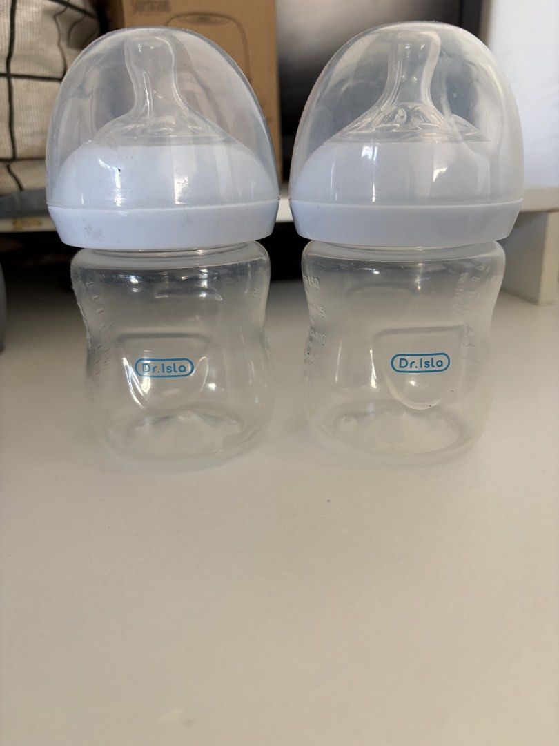 Dr. Isla Baby Bottles (2 pcs) (Category: Breastfeeding & Bottle Feeding) located in San Pedro. Submitted by bluegray08 (Listing ID 1455862557, Image 1). Description: - Set of 2 Dr. Isla baby bottles - Clear plastic bottles with white collars - Clear nipples included - Dr. Isla logo on each bottle - Perfect for feeding your little one - Ready for a new home.