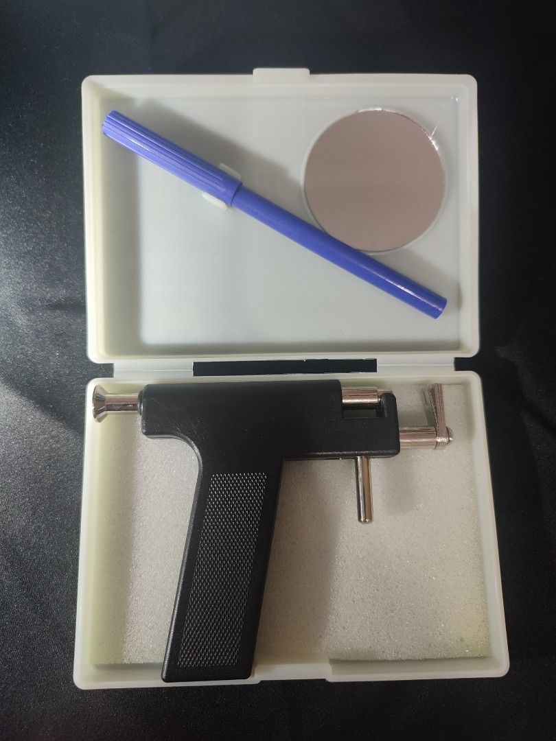 Ear Piercing Gun Kit with Studs and Accessories (Category: Earrings) located in Marikina City. Submitted by surplusbuffet (Listing ID 1455943189, Image 2). Description: - Complete ear piercing kit - Includes piercing gun, marker, and small mirror - Comes with a box of starter earrings and a bag of earring backs - All items organized in a convenient case - Ideal for personal use or professional services.