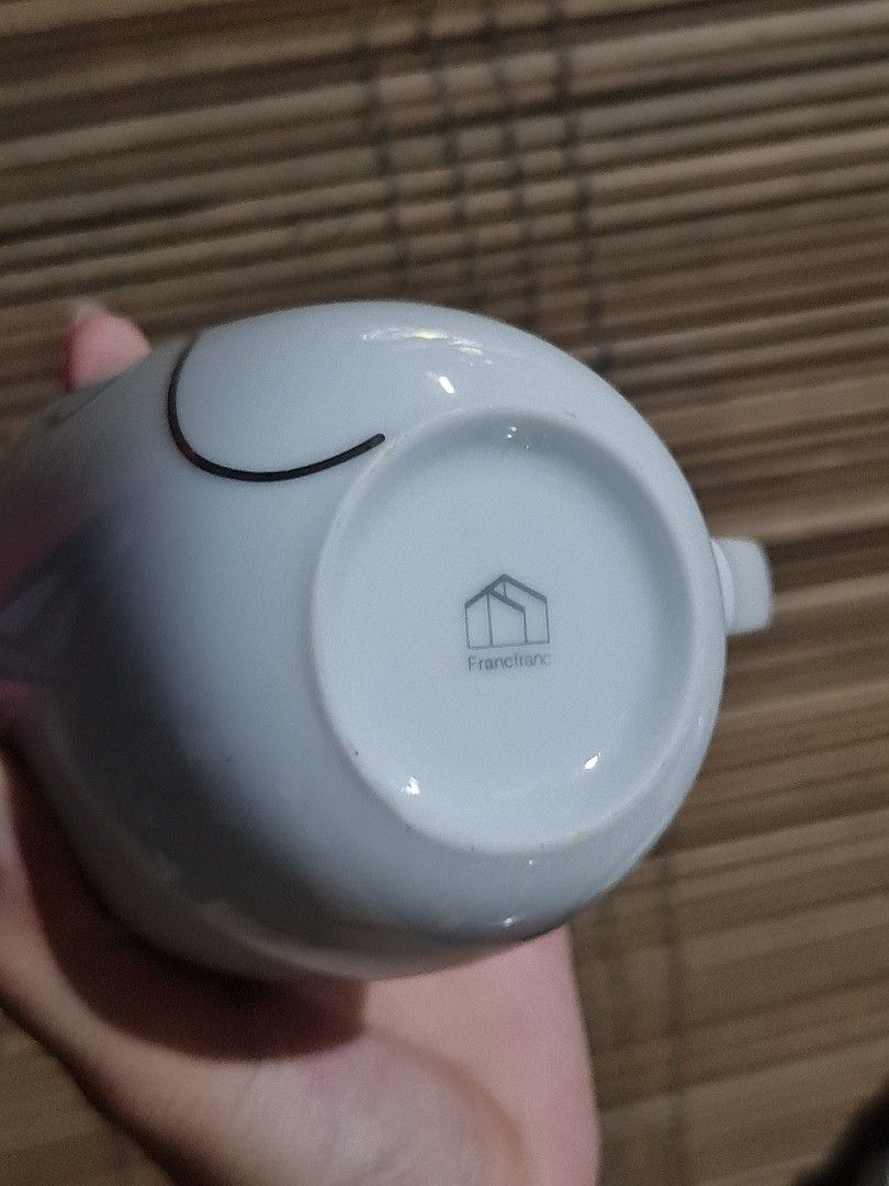 Francfranc Silver Swirl Mug (Category: Coffee & Tea Tableware) located in Caloocan City. Submitted by shane_malik (Listing ID 1455895251, Image 2). Description: Francfranc - Classic white mug with a simple silver swirl design. - Features the Francfranc logo on the bottom. - Ideal for your morning coffee or tea. - Interior is clean. - Handle is intact and sturdy. - A minimalist yet lovely piece to enhance your kitchenware collection..
