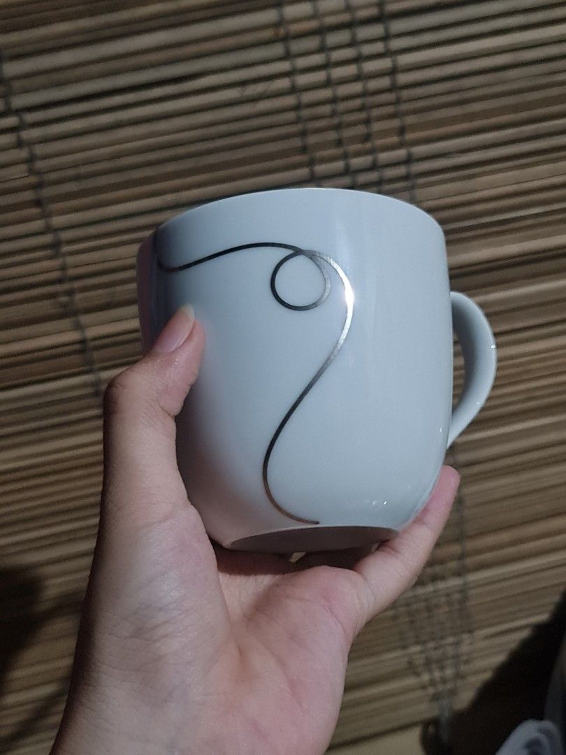 Francfranc Silver Swirl Mug (Category: Coffee & Tea Tableware) located in Caloocan City. Submitted by shane_malik (Listing ID 1455895251, Image 1). Description: Francfranc - Classic white mug with a simple silver swirl design. - Features the Francfranc logo on the bottom. - Ideal for your morning coffee or tea. - Interior is clean. - Handle is intact and sturdy. - A minimalist yet lovely piece to enhance your kitchenware collection..