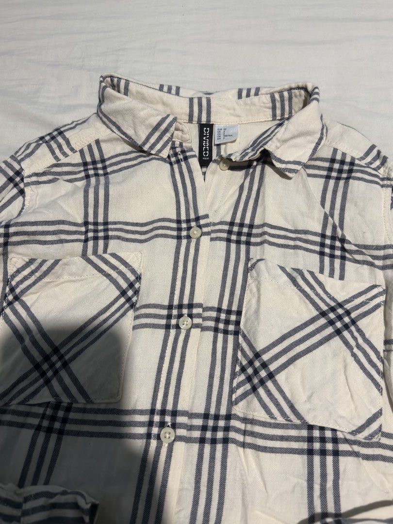 H&M Divided Plaid Long Sleeves (Category: Longsleeves) located in Santa Rosa. Submitted by micstuff (Listing ID 1456011152, Image 3). Description: - Cream long sleeve shirt - Navy blue plaid pattern - Button-up front - Two chest pockets - Collared neckline - Relaxed fit - Ideal for casual wear - Pairs well with jeans or shorts.