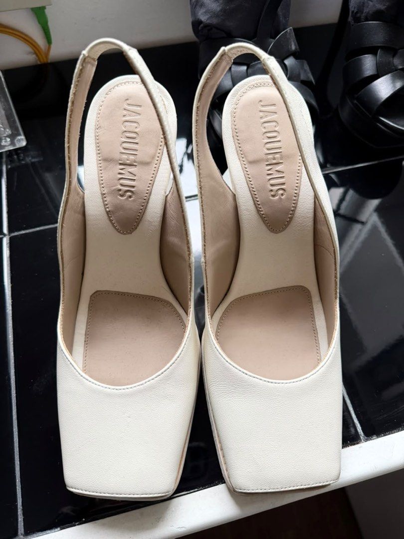 Jacquemus White Slingback Heels with Sculptural Heel (Category: Heels) located in Quezon City. Submitted by adnct (Listing ID 1455993729, Image 2). Description: - Brand: Jacquemus - Color: White - Style: Slingback Heels - Features: Unique sculptural heel, Square toe, Secure slingback strap - Versatile: Dress up or down for any outfit.