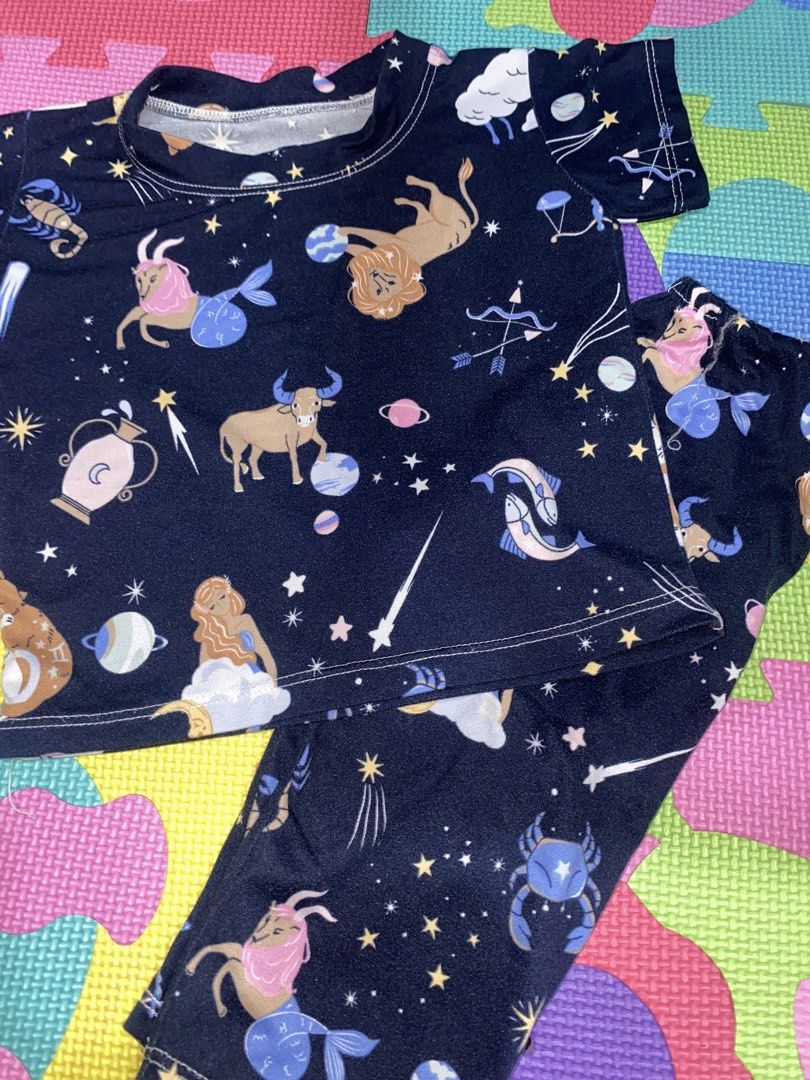 Kids Zodiac Constellation Pajama Set (Category: Babies & Kids Fashion) located in Manila. Submitted by narsg (Listing ID 1455995977, Image 3). Description: - Fun dark blue pajama set with a vibrant zodiac constellation print. - Features popular star signs like Leo, Taurus, Gemini, and more. - Made from soft, comfortable fabric for a great night's sleep. - Top has short sleeves for breathability. - Bottoms are full length for cozy coverage. - Idea