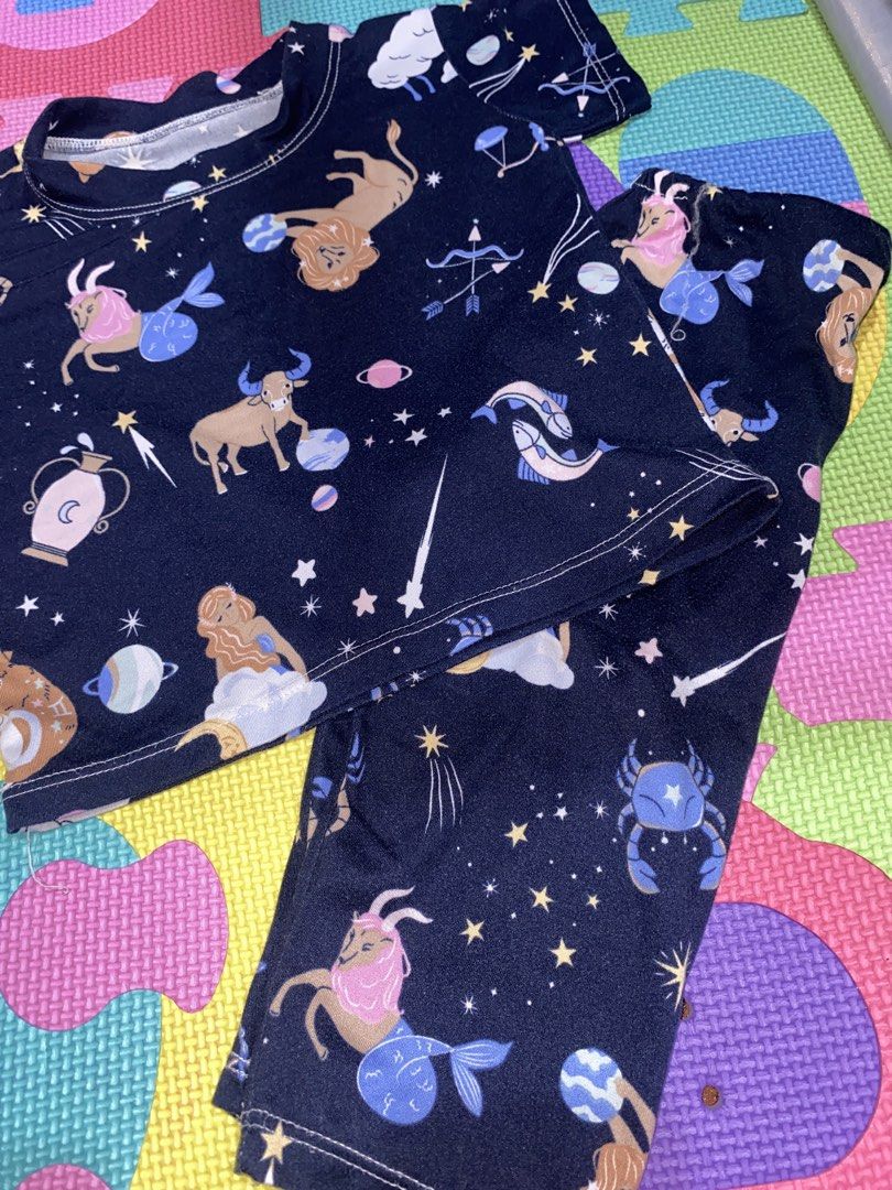 Kids Zodiac Constellation Pajama Set (Category: Babies & Kids Fashion) located in Manila. Submitted by narsg (Listing ID 1455995977, Image 1). Description: - Fun dark blue pajama set with a vibrant zodiac constellation print. - Features popular star signs like Leo, Taurus, Gemini, and more. - Made from soft, comfortable fabric for a great night's sleep. - Top has short sleeves for breathability. - Bottoms are full length for cozy coverage. - Idea