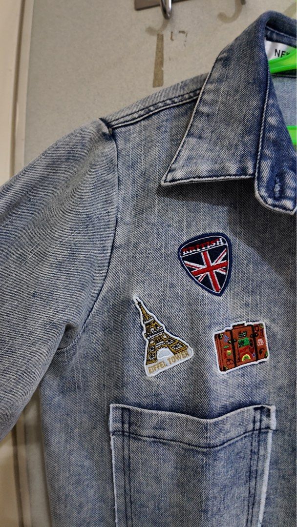 Long Denim Jacket with Patches (Category: Coats, Jackets and Outerwear) located in Malabon City. Submitted by jhensengo (Listing ID 1456013618, Image 2). Description: - Cool long denim jacket - Acid wash effect - Embroidered patches: Eiffel Tower, Union Jack, suitcase, fighter jet, Japan/Mt. Fuji - Frayed hem and cuffs - Button-up front - Two chest pockets - Great statement piece.