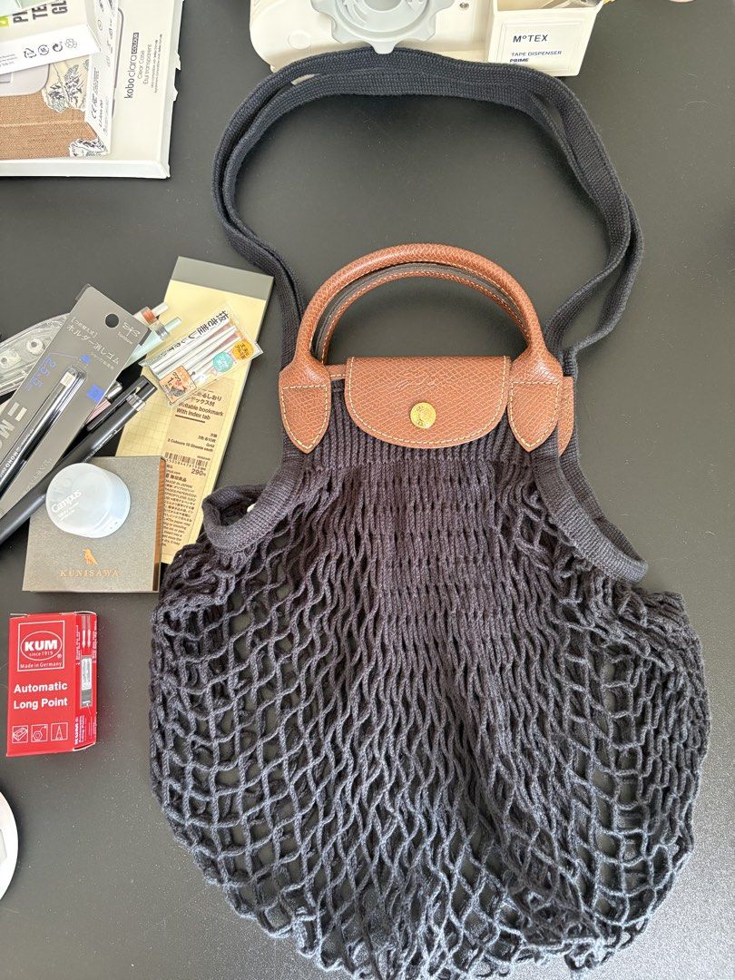 Longchamp Le Pliage Filet Bag in Large (Category: Luxury Bags & Wallets) located in Paranaque City. Submitted by chicrepeats (Listing ID 1455901061, Image 1). Description: - Black net bag - Brown leather handles and trim - Snap closure with Longchamp logo - Ideal for shopping or everyday use - Stylish and practical .