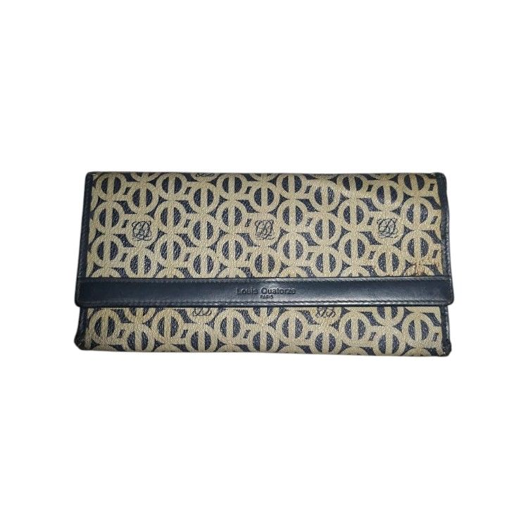 Louis Quatorze Paris Monogram Wallet (Category: Wallets & Card holders) located in San Juan (Cabalian). Submitted by ec8thrift (Listing ID 1456005267, Image 1). Description: - Louis Quatorze Paris wallet - Classic beige and navy monogram pattern - Genuine leather trim and interior - Features multiple card slots and compartments - Secure snap closure - Perfect for keeping your essentials organized.