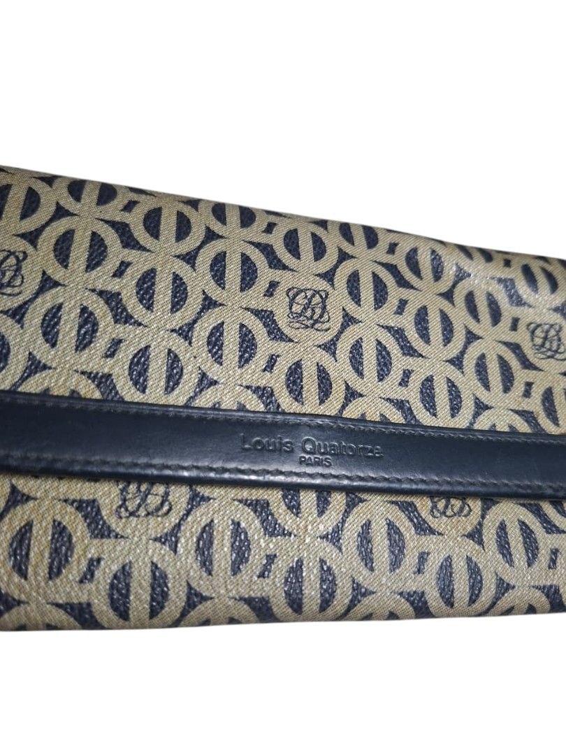 Louis Quatorze Paris Monogram Wallet (Category: Wallets & Card holders) located in San Juan (Cabalian). Submitted by ec8thrift (Listing ID 1456005267, Image 2). Description: - Louis Quatorze Paris wallet - Classic beige and navy monogram pattern - Genuine leather trim and interior - Features multiple card slots and compartments - Secure snap closure - Perfect for keeping your essentials organized.