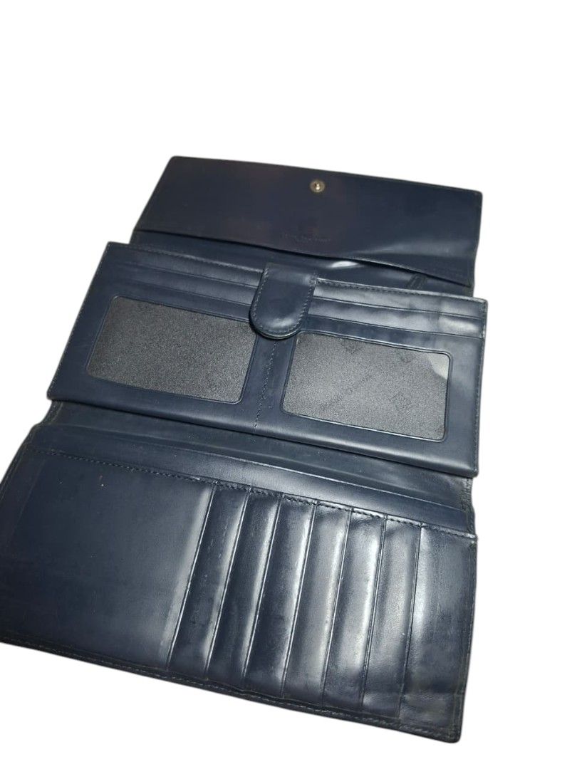 Louis Quatorze Paris Monogram Wallet (Category: Wallets & Card holders) located in San Juan (Cabalian). Submitted by ec8thrift (Listing ID 1456005267, Image 3). Description: - Louis Quatorze Paris wallet - Classic beige and navy monogram pattern - Genuine leather trim and interior - Features multiple card slots and compartments - Secure snap closure - Perfect for keeping your essentials organized.